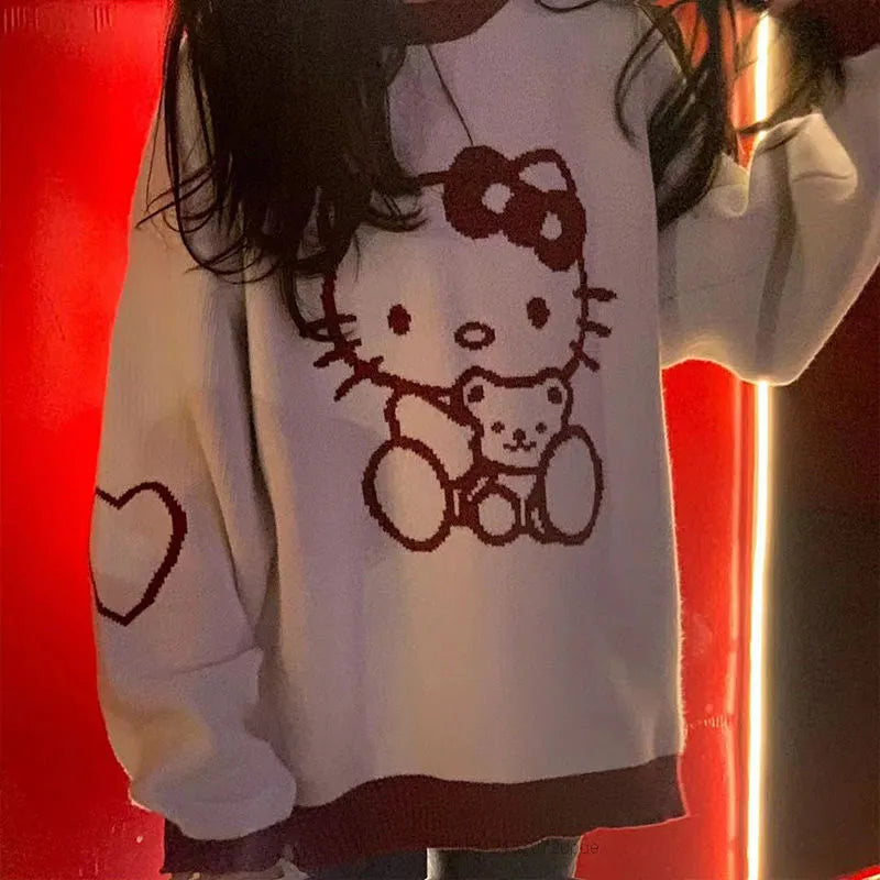 Top tipo suéter suelto de manga larga con cuello redondo de Hello Kitty